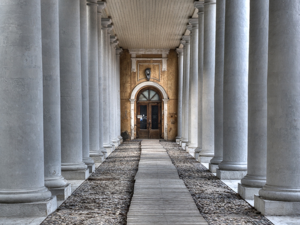 White columns leading to a closed door