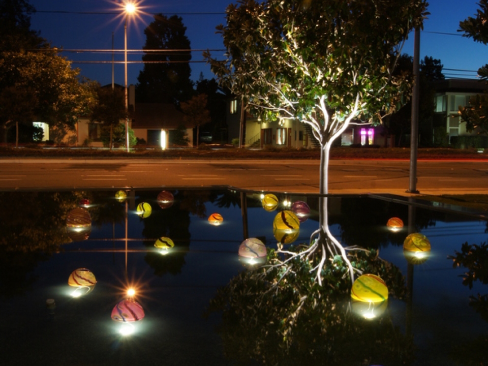 Lights floating on still water at night