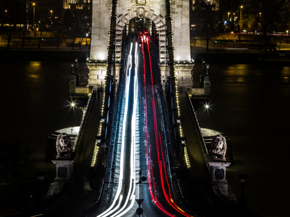 Cars travelling across a bridge at night
